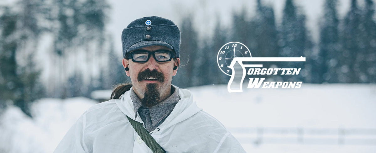 Ian McCollum in a snowy landscape with 'Forgotten Weapons' logo