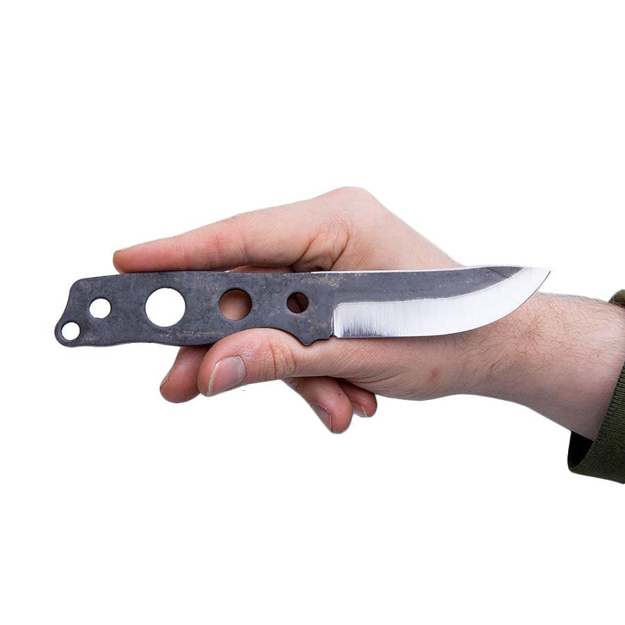 The spine is ground and beveled to strike sparks from ferro rods.