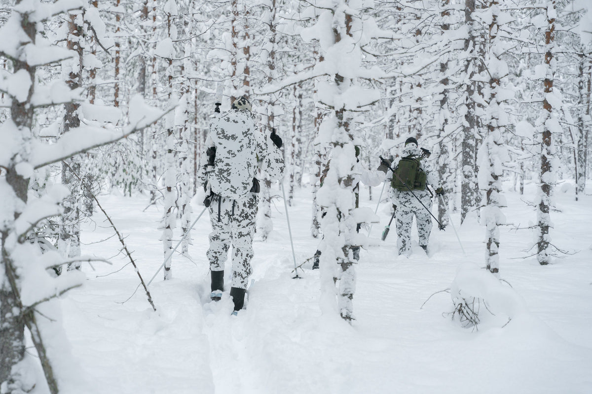 On the left L5 Thermal Patrol Coverall; on the right L7 camouflage anorak and pants