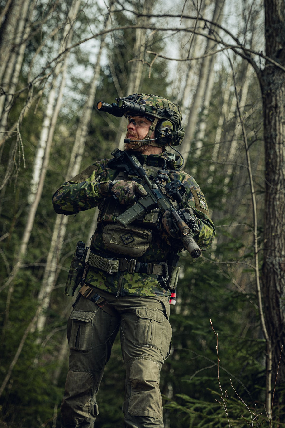 Person in camouflage military gear walking in a forest